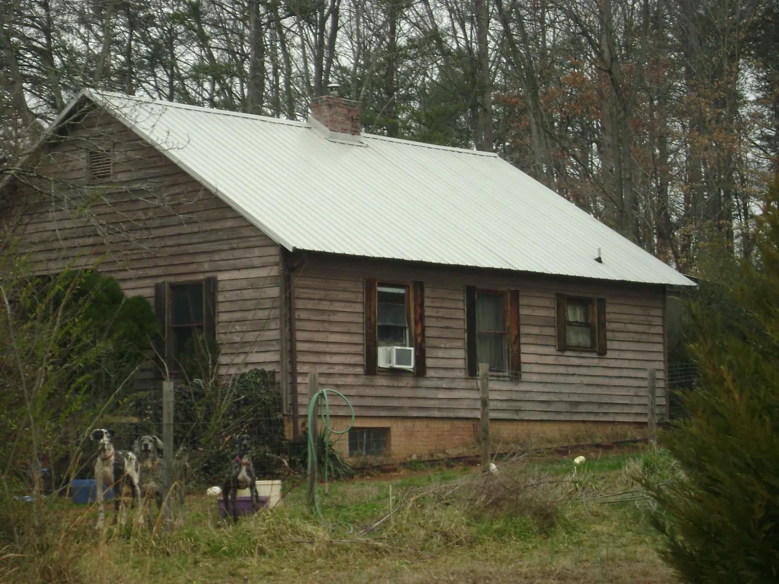 White metal roof on an old wood sided farmhouse, from a Metal Roof Installation job in Rossford